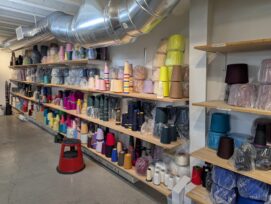 Cashmere yarn of various colors on shelves.